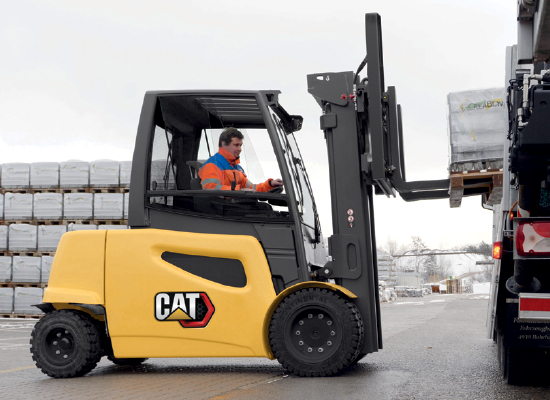 Worker moving a pallet with Cat class i forklift