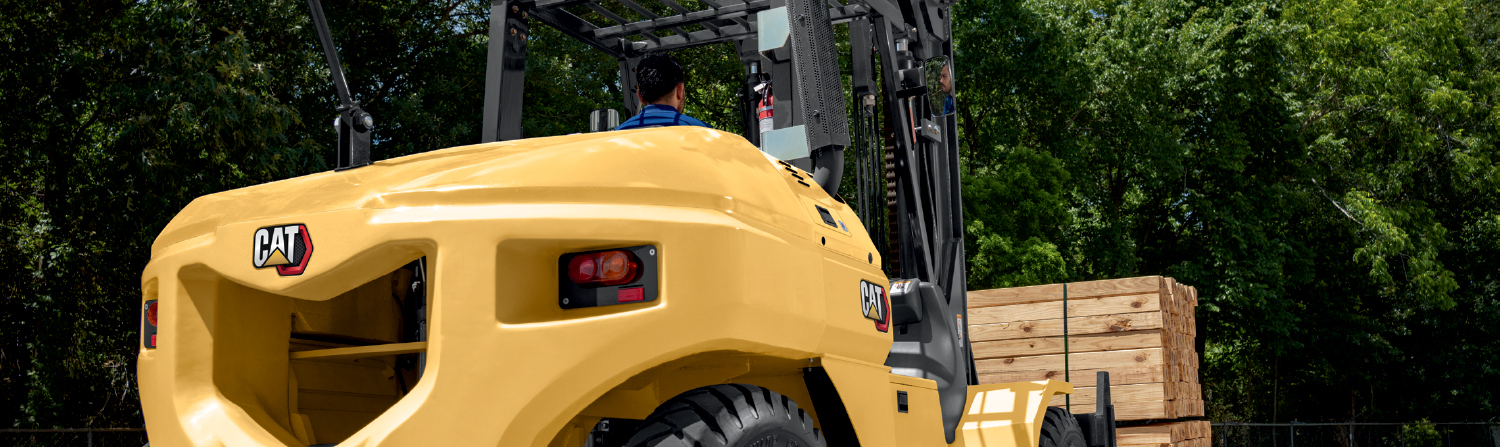 Large CAT Forklift Truck Working Outdoors at Night