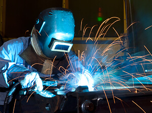 Welder Working on a Forklift Part