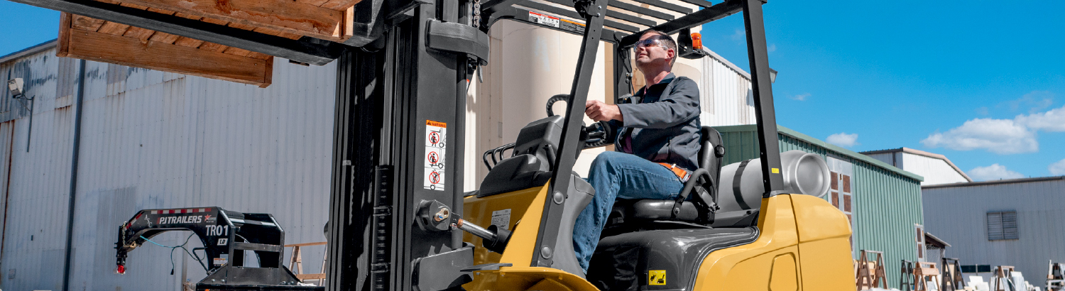 CAT Forklift Moving Materials Outdoors