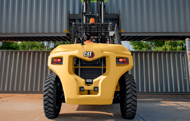 Class 5 CAT Forklift Moving Materials Outdoors at Night