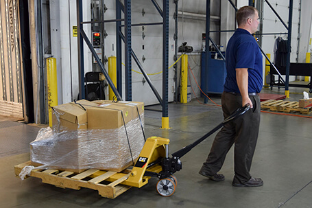 Operator pulling Cat pallet jack