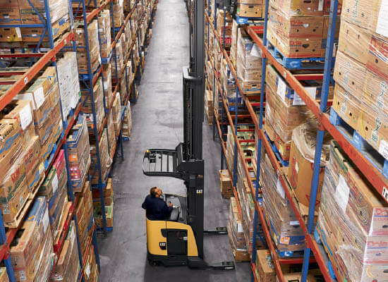 Operator extending mast of Cat pantograph reach truck to reach top shelf