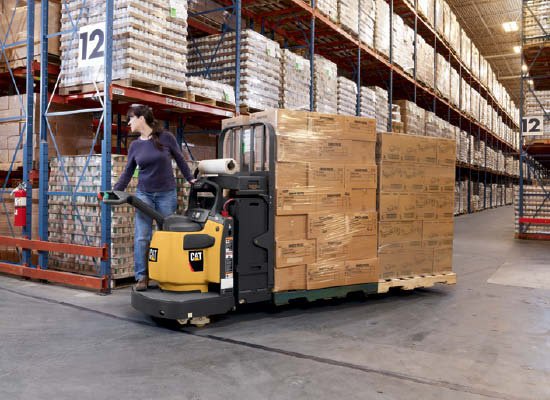 Worker turning corner on Cat walkie end rider carrying stack of boxes