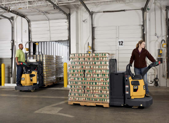 Two workers distributing pallets full of materials with Cat walkie end riders