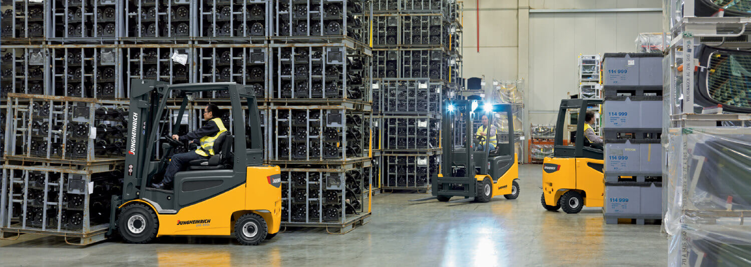 3 Jungheinrich forklifts driving around in warehouse