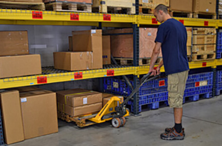 Worker Retrieving Merchandise with a Jungheinrich Hand Pallet Jack