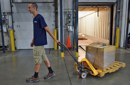 Worker Walking with Merchandise on a Jungheinrich Hand Pallet Jack