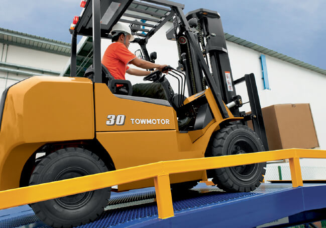 Towmotor forklift ascending ramp