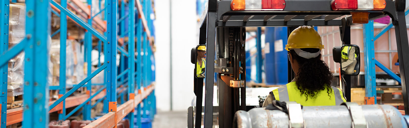 Forklift operator driving lift truck forward