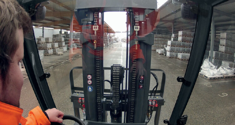 Man driving forklift in rain and snow