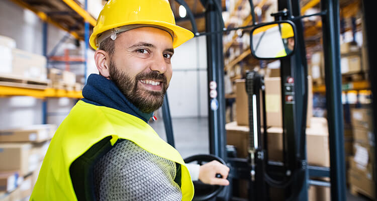 employee driving forklift backwards