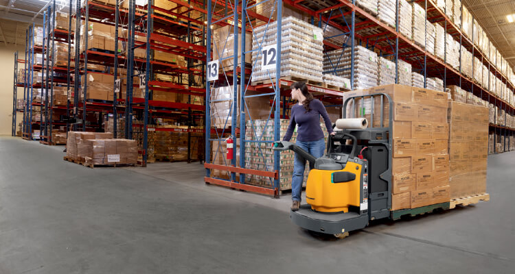 Worker loading materials on pallet into truck using a Jungheinrich walkie pallet truck