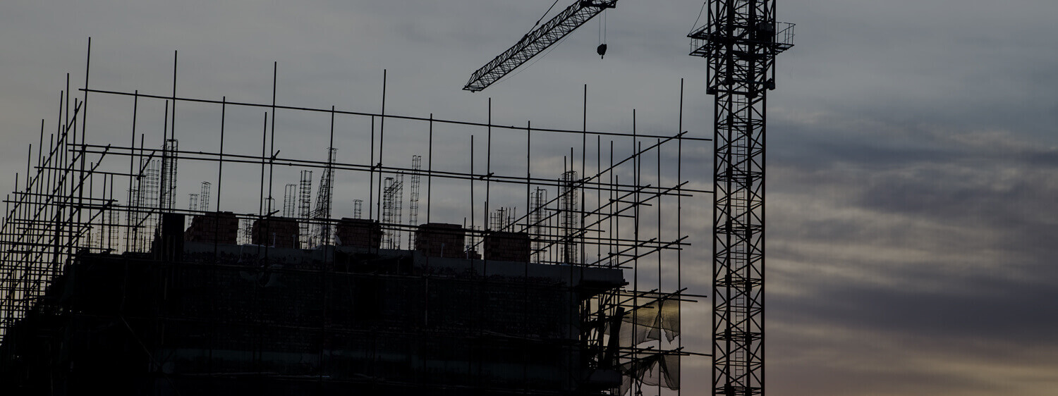 Shot of a Building Under Construction and a Crane