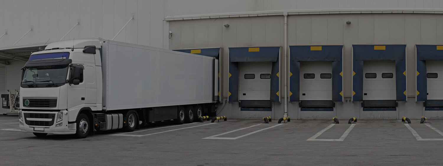 An 18-Wheeler Parked at a Warehouse Dock