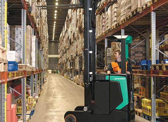 Operator Using a Mitsubishi Moving Mast Reach Truck in a Warehouse