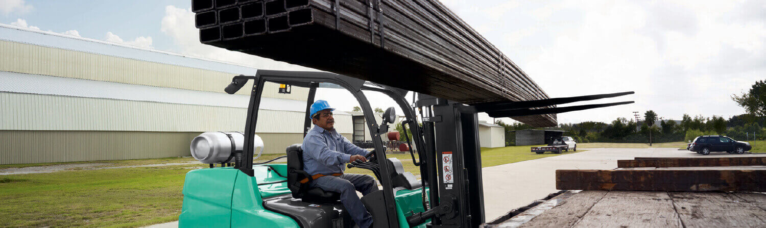 Operator moving rods onto truck