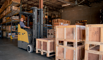 Pallets Being Stacked by a Cat Stand-Up Counterbalanced Lift Truck�