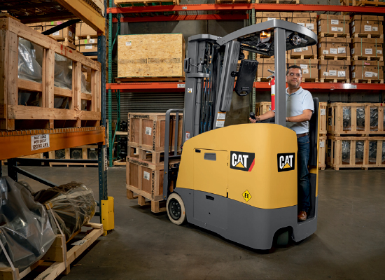 Operator Carrying Loads Through a Warehouse With a Cat Forklift