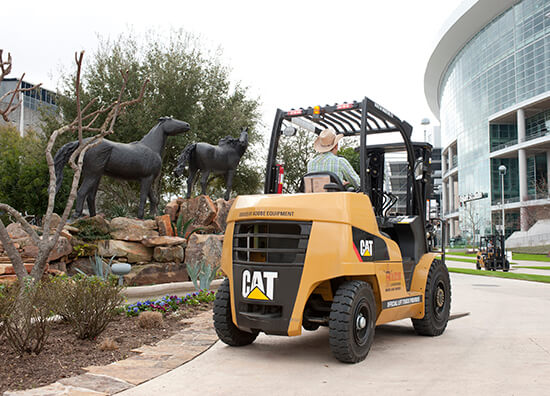 CAT Forklift next to a Horse Statue Garden at the Rodeo