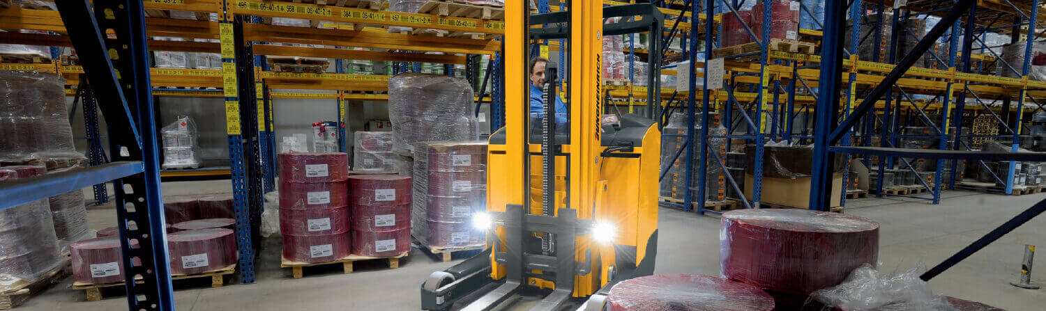 Lights on a Jungheinrich Forklift Shining While in Use in a Factory