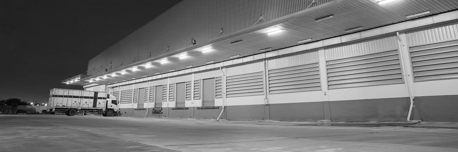 Gray background of a loading truck in front of garage doors