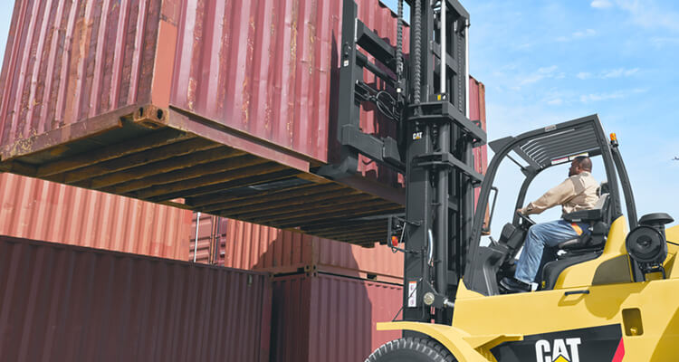 cat forklift carrying heavy shipping container