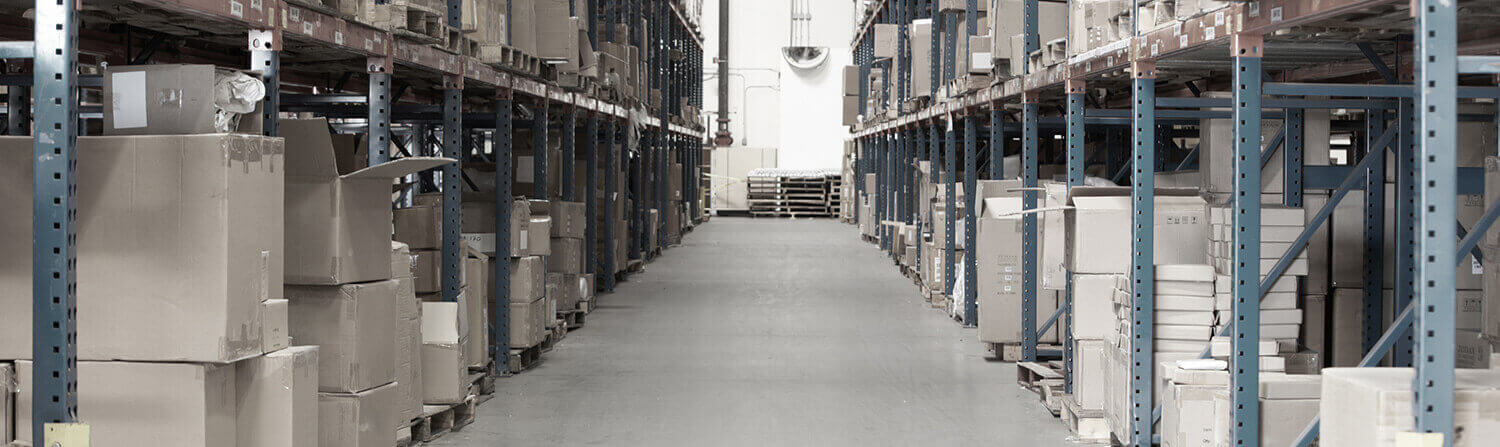 Background shot of gray-toned warehouse aisle with cardboard boxes